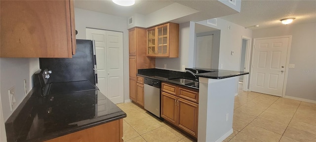 1023 S Hiawassee Rd Unit 4017, Orlando, FL 32835 - kitchen featuring dishwasher, brown cabinets, light tile patterned floors, and freestanding refrigerator