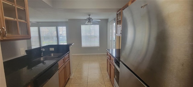 1023 S Hiawassee Rd Unit 4017, Orlando, FL 32835 - kitchen featuring appliances with stainless steel finishes, dark countertops, brown cabinets, a ceiling fan, and light tile patterned flooring