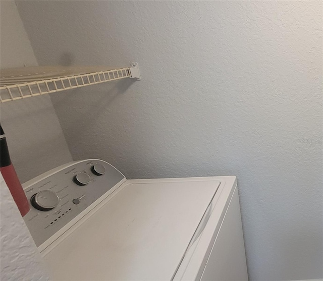 1023 S Hiawassee Rd Unit 4017, Orlando, FL 32835 - laundry area featuring washer / dryer and a textured wall