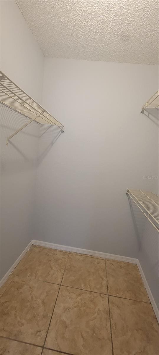 1023 S Hiawassee Rd Unit 4017, Orlando, FL 32835 - walk in closet with light tile patterned flooring