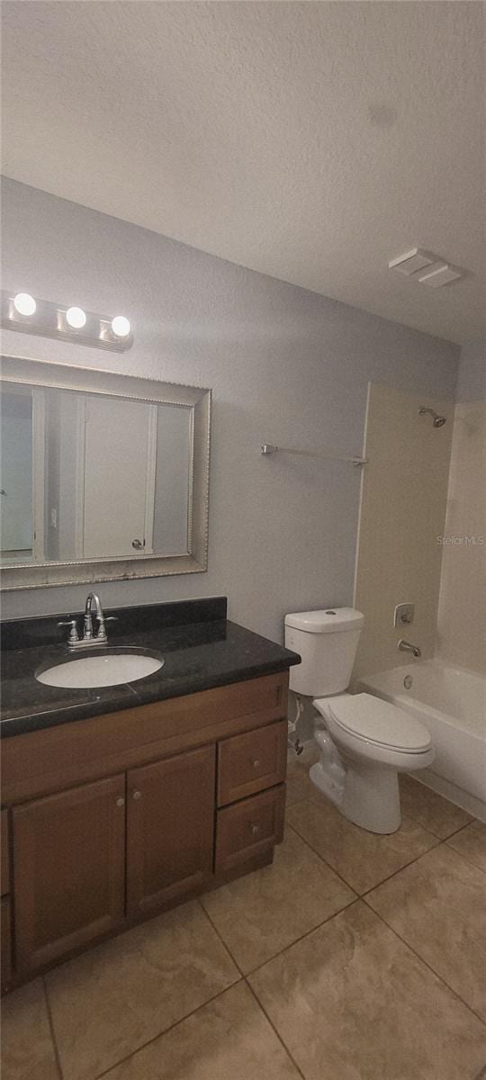1023 S Hiawassee Rd Unit 4017, Orlando, FL 32835 - full bathroom with vanity, tile patterned floors, shower / bath combination, and a textured ceiling