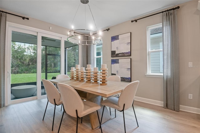 222 Thornberry Way, Palm Coast, FL 32164 - dining room with light wood-style floors and a chandelier