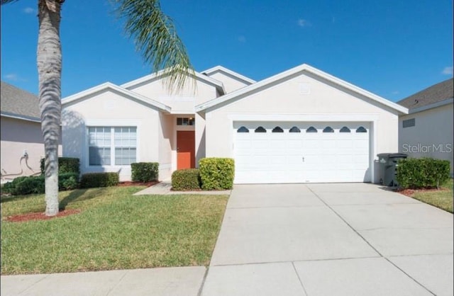 8121 Fan Palm Way, Kissimmee, FL 34747 - ranch-style home featuring a front yard, a garage, driveway, and stucco siding