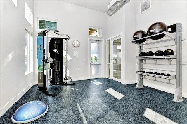 7770 Sandy Ridge Dr Unit 142, Kissimmee, FL 34747 - exercise area featuring baseboards and a towering ceiling