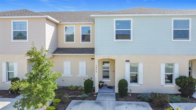 4850 Coral Castle Dr, Kissimmee, FL 34746 - townhome / multi-family property with a shingled roof and stucco siding