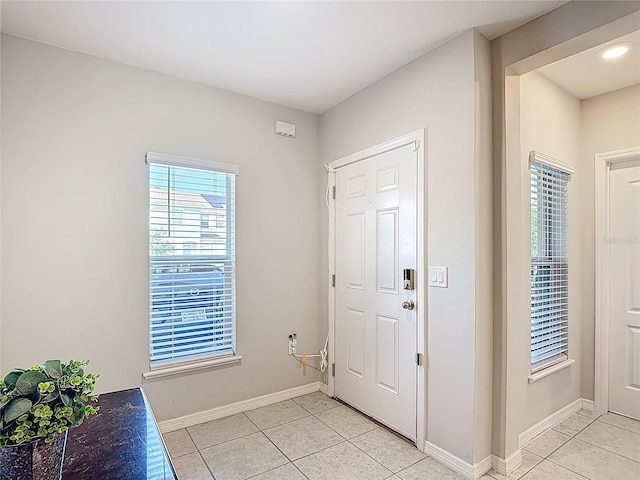 4850 Coral Castle Dr, Kissimmee, FL 34746 - foyer with light tile patterned floors and baseboards