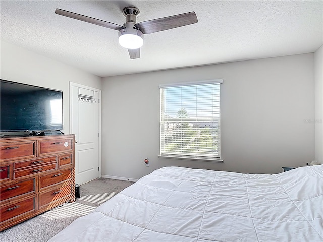 4850 Coral Castle Dr, Kissimmee, FL 34746 - bedroom featuring light carpet, a ceiling fan, and a textured ceiling