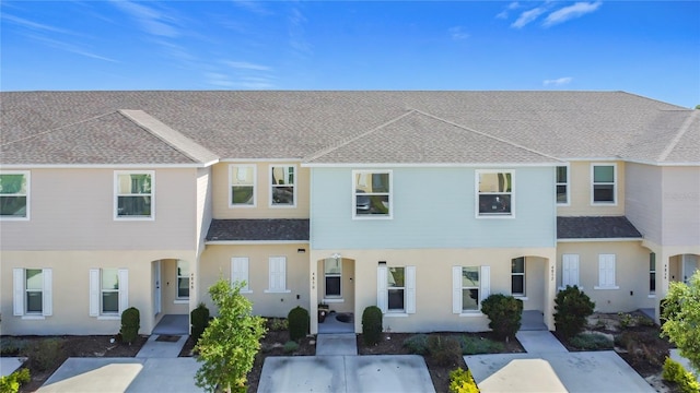 4850 Coral Castle Dr, Kissimmee, FL 34746 - townhome / multi-family property with a shingled roof and stucco siding