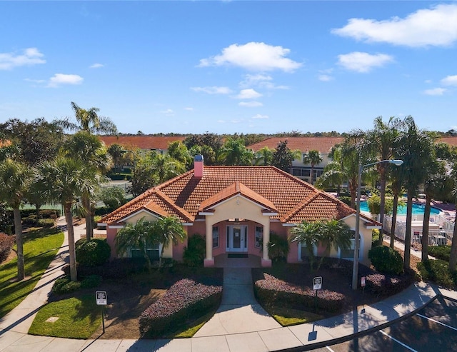 4850 Coral Castle Dr, Kissimmee, FL 34746 - mediterranean / spanish-style house with a tiled roof, stucco siding, and a chimney