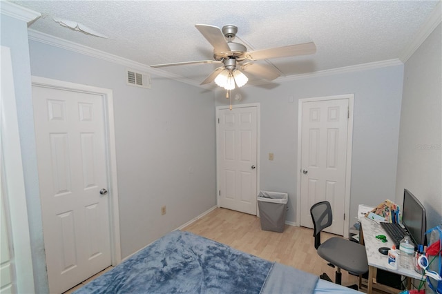139 Oyster Bay Cir Unit 200, Altamonte Springs, FL 32701 - bedroom with light wood-style flooring, crown molding, a textured ceiling, ceiling fan, and baseboards