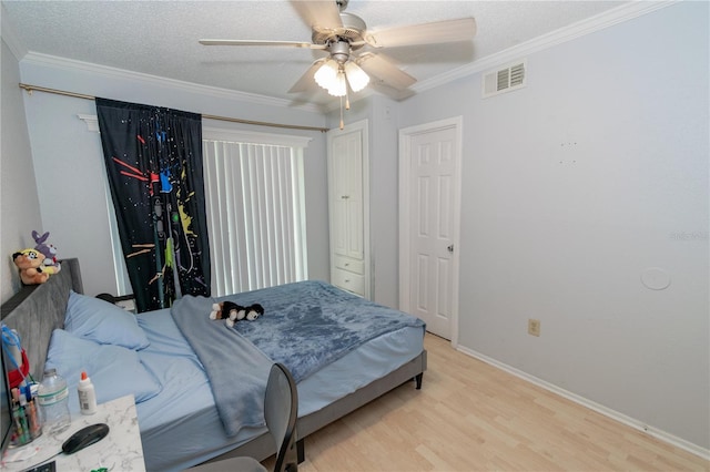 139 Oyster Bay Cir Unit 200, Altamonte Springs, FL 32701 - bedroom featuring light wood finished floors, ornamental molding, baseboards, a textured ceiling, and a ceiling fan
