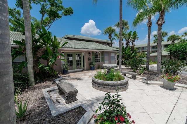 139 Oyster Bay Cir Unit 200, Altamonte Springs, FL 32701 - back of house with french doors, a tiled roof, and stucco siding