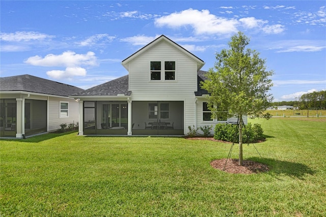 215 Thornberry Way, Palm Coast, FL 32164 - rear view of property with a sunroom, a shingled roof, and a lawn