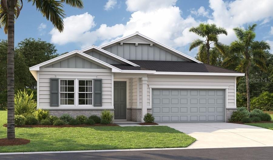 219 Thornberry Way, Palm Coast, FL 32164 - view of front of house with board and batten siding, brick siding, driveway, and a front lawn