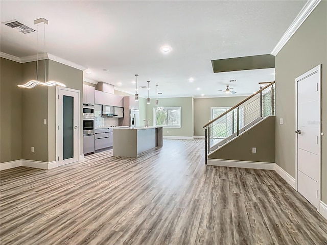 1870 Brentwood Ct, Davenport, FL 33837 - kitchen with crown molding, appliances with stainless steel finishes, baseboards, open floor plan, and wood finished floors