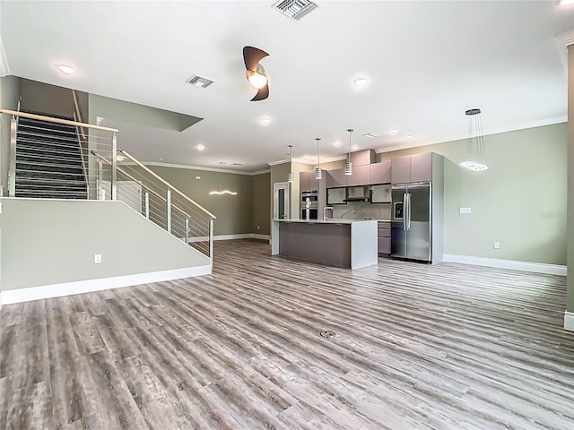 1870 Brentwood Ct, Davenport, FL 33837 - kitchen featuring high end refrigerator, baseboards, open floor plan, ornamental molding, and light wood-type flooring