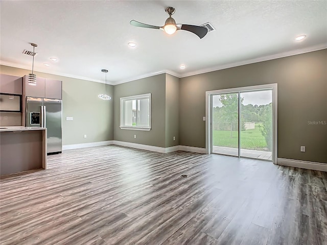 1870 Brentwood Ct, Davenport, FL 33837 - unfurnished living room featuring wood finished floors, ornamental molding, ceiling fan, baseboards, and recessed lighting