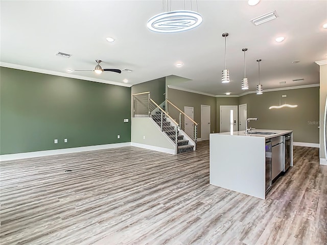 1870 Brentwood Ct, Davenport, FL 33837 - kitchen featuring a sink, baseboards, wood finished floors, a kitchen island with sink, and crown molding