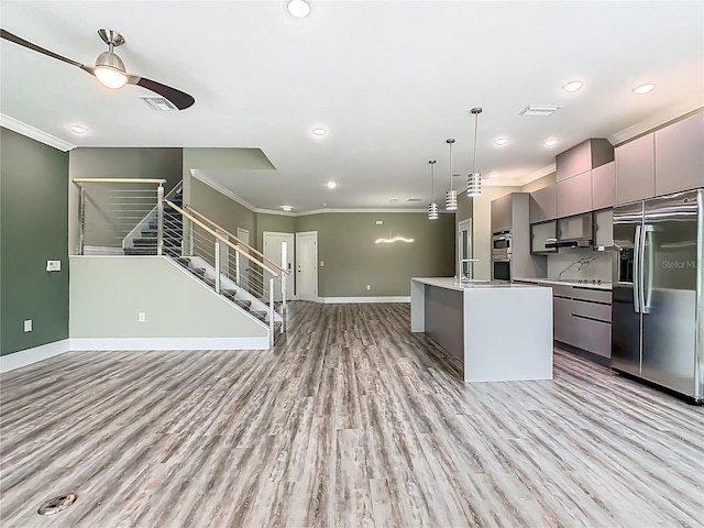 1870 Brentwood Ct, Davenport, FL 33837 - kitchen with appliances with stainless steel finishes, open floor plan, gray cabinets, modern cabinets, and ornamental molding