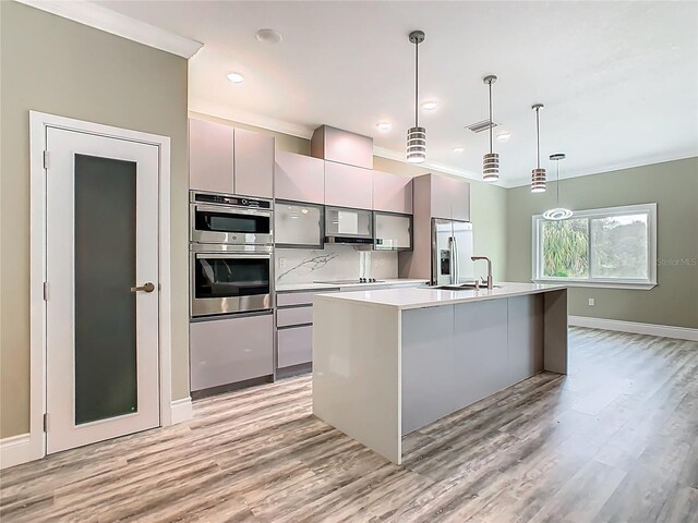 1870 Brentwood Ct, Davenport, FL 33837 - kitchen with stainless steel appliances, gray cabinets, ornamental molding, light wood-style flooring, and light countertops