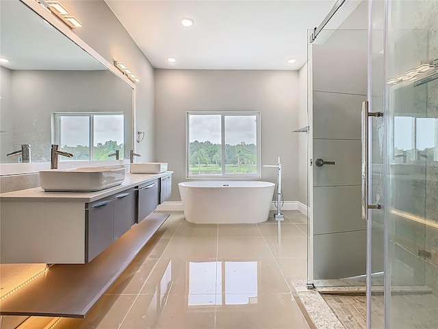 1870 Brentwood Ct, Davenport, FL 33837 - bathroom with baseboards, double vanity, a soaking tub, a shower stall, and tile patterned flooring