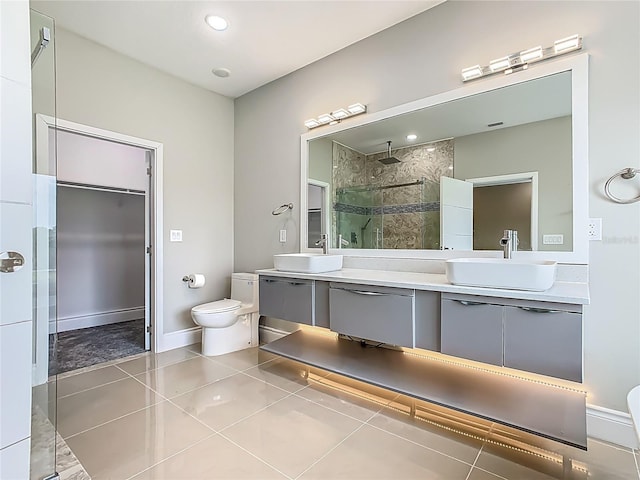 1870 Brentwood Ct, Davenport, FL 33837 - bathroom with toilet, double vanity, a stall shower, tile patterned flooring, and baseboards