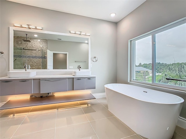 1870 Brentwood Ct, Davenport, FL 33837 - full bath featuring double vanity, a freestanding bath, a stall shower, baseboards, and tile patterned flooring