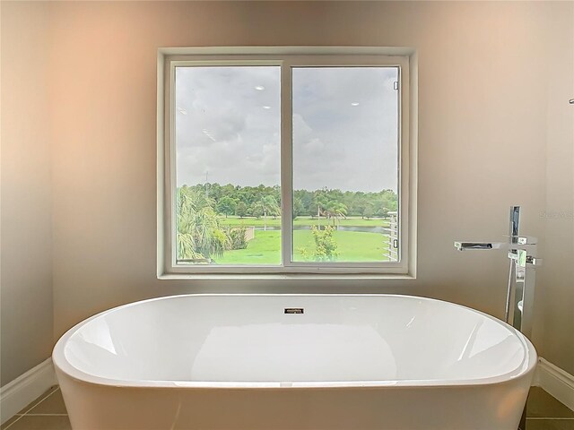 1870 Brentwood Ct, Davenport, FL 33837 - bathroom featuring a freestanding tub, tile patterned flooring, and baseboards