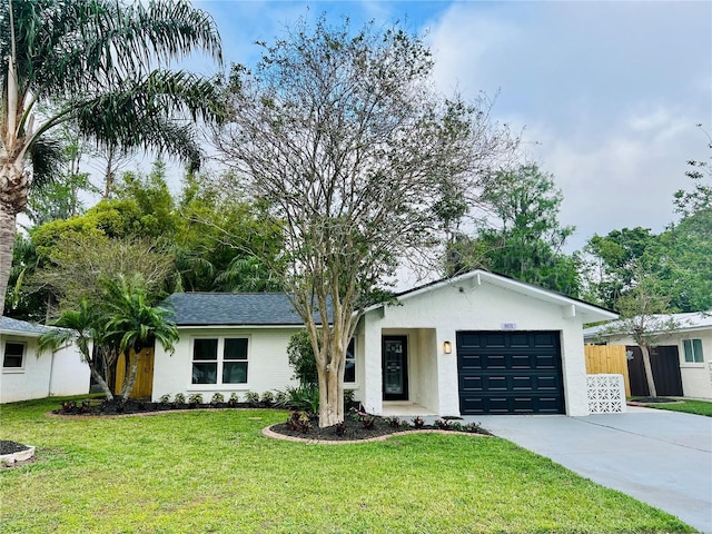 801 Leeward Way, Palm Harbor, FL 34685 - view of front facade with a garage, driveway, and stucco siding