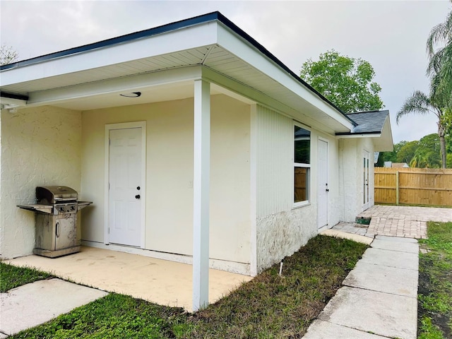 801 Leeward Way, Palm Harbor, FL 34685 - view of side of home featuring stucco siding and a patio