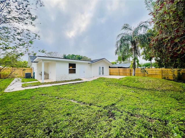 801 Leeward Way, Palm Harbor, FL 34685 - back of property with a patio area, central AC unit, french doors, and stucco siding