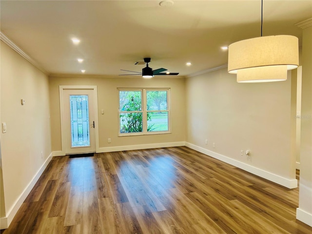 801 Leeward Way, Palm Harbor, FL 34685 - empty room featuring ornamental molding, healthy amount of natural light, baseboards, dark wood-style flooring, and recessed lighting