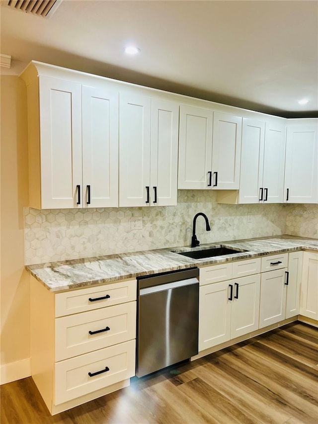 801 Leeward Way, Palm Harbor, FL 34685 - kitchen featuring a sink, dishwasher, recessed lighting, light stone counters, and white cabinets