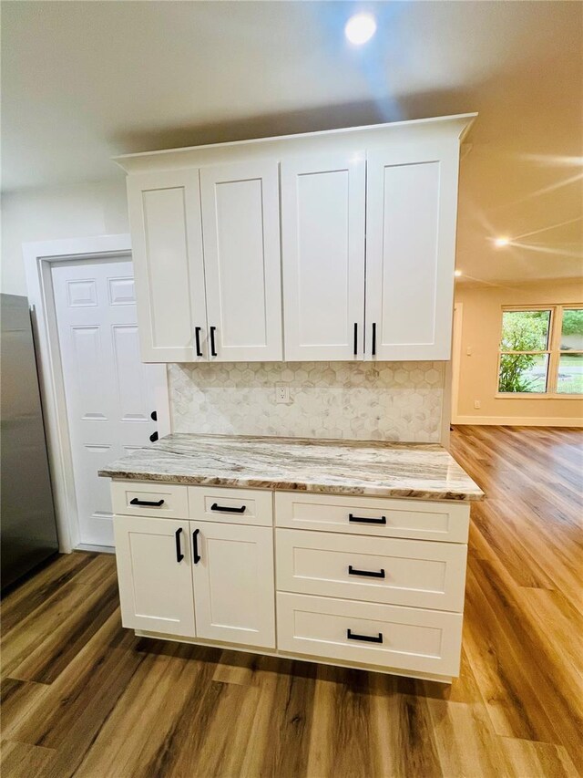 801 Leeward Way, Palm Harbor, FL 34685 - detailed view of wood finished floors, tasteful backsplash, recessed lighting, and stainless steel refrigerator