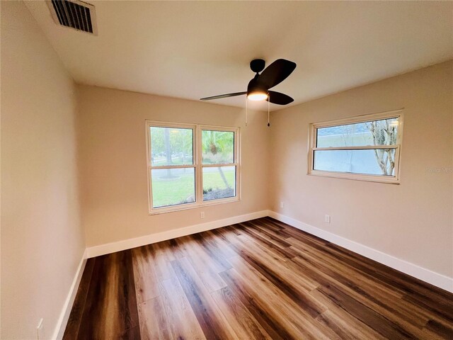 801 Leeward Way, Palm Harbor, FL 34685 - empty room featuring dark wood finished floors, baseboards, and ceiling fan