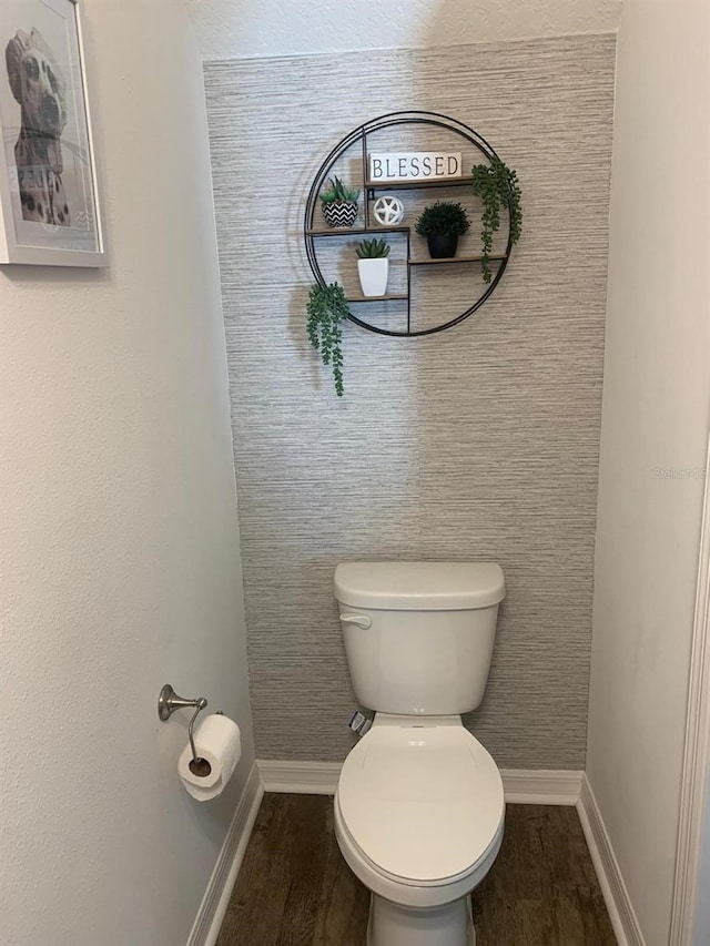 892 Grandin St, Davenport, FL 33837 - bathroom with toilet, wood finished floors, and baseboards