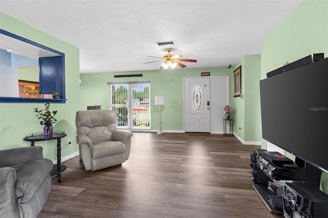 1566 Providence Blvd, Deltona, FL 32725 - living room with a ceiling fan, wood finished floors, baseboards, and a textured ceiling