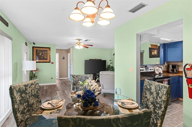 1566 Providence Blvd, Deltona, FL 32725 - dining room featuring wood finished floors, a chandelier, and a ceiling fan