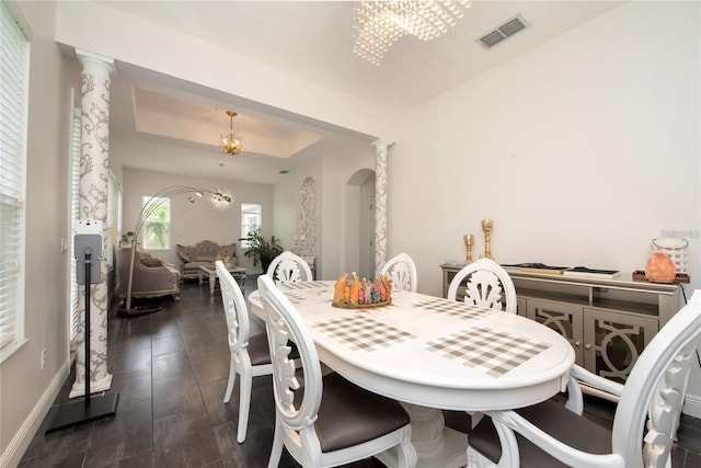 5231 Lemon Twist Ln, Windermere, FL 34786 - dining space featuring a chandelier, decorative columns, and a tray ceiling