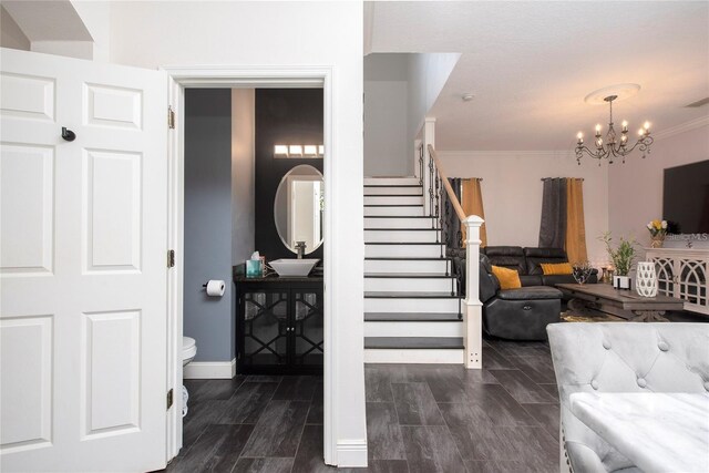 5231 Lemon Twist Ln, Windermere, FL 34786 - staircase featuring a chandelier and ornamental molding