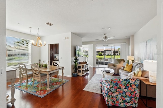 1225 Bella Cara Ct Unit 1, Davenport, FL 33896 - living room with wood finished floors, a chandelier, a ceiling fan, and baseboards