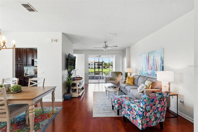 1225 Bella Cara Ct Unit 1, Davenport, FL 33896 - living area with a chandelier, wood finished floors, a ceiling fan, and baseboards