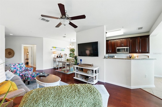 1225 Bella Cara Ct Unit 1, Davenport, FL 33896 - living area featuring ceiling fan, light wood-style floors, baseboards, and a chandelier
