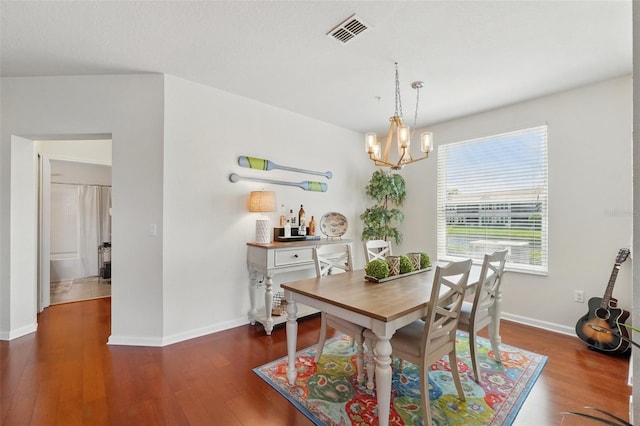 1225 Bella Cara Ct Unit 1, Davenport, FL 33896 - dining room with a chandelier, wood finished floors, and baseboards