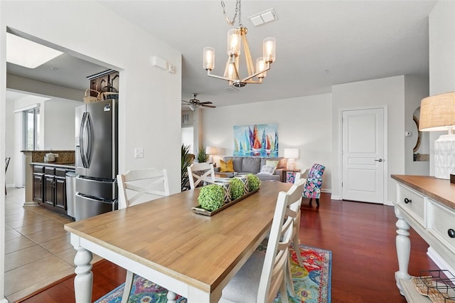 1225 Bella Cara Ct Unit 1, Davenport, FL 33896 - dining space with a chandelier, a ceiling fan, baseboards, and dark wood-style floors