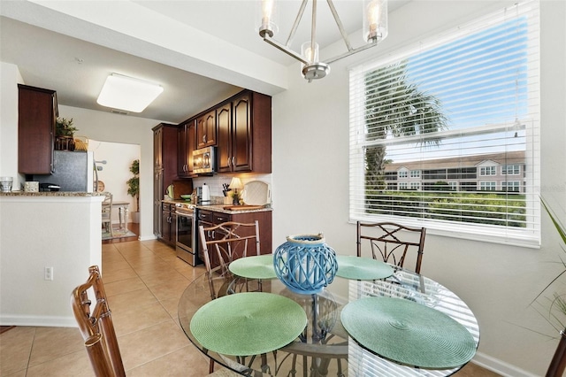 1225 Bella Cara Ct Unit 1, Davenport, FL 33896 - dining space with light tile patterned floors, plenty of natural light, and baseboards