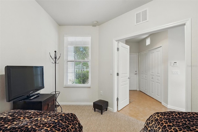 1225 Bella Cara Ct Unit 1, Davenport, FL 33896 - bedroom featuring multiple windows, baseboards, and light carpet