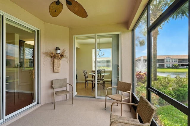 1225 Bella Cara Ct Unit 1, Davenport, FL 33896 - sunroom / solarium featuring a water view, ceiling fan, and carpet