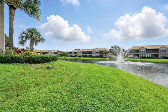 1225 Bella Cara Ct Unit 1, Davenport, FL 33896 - view of green lawn featuring a water view, a residential view, and driveway