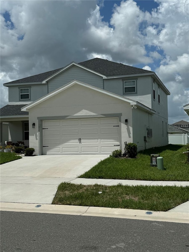 1016 Cascade Dr, Davenport, FL 33837 - view of front of property featuring driveway, stucco siding, a garage, a shingled roof, and a front yard